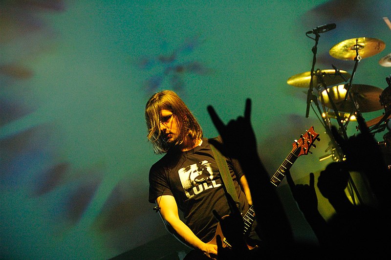 Steven Wilson from Porcupine Tree performing with a fans rock on sign in view.
