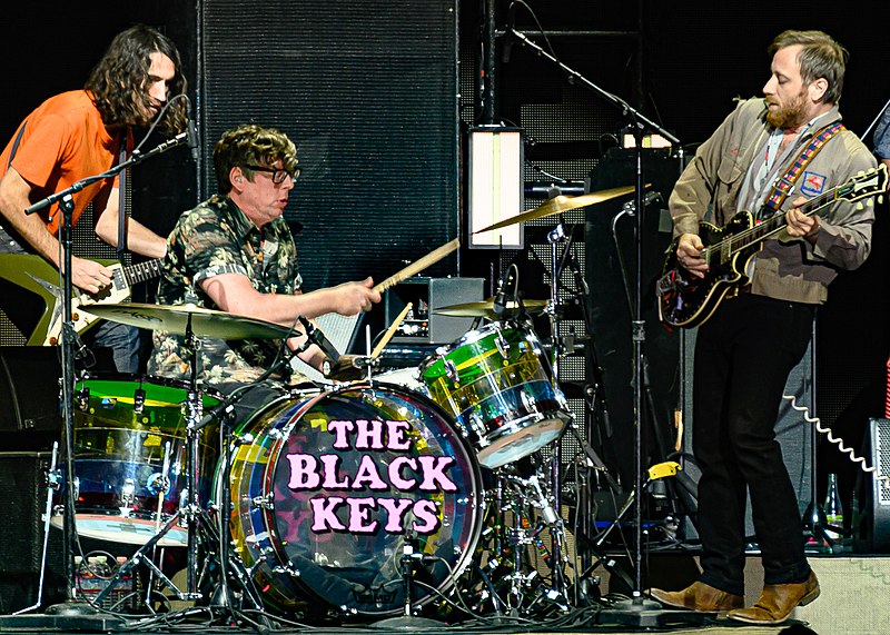 The Black keys performing live with an additional guitarist in the background.